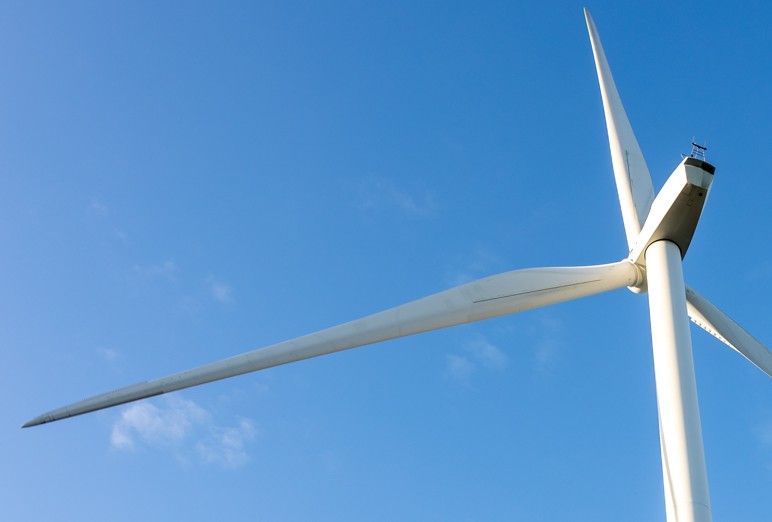 Large wind turbine against blue sky