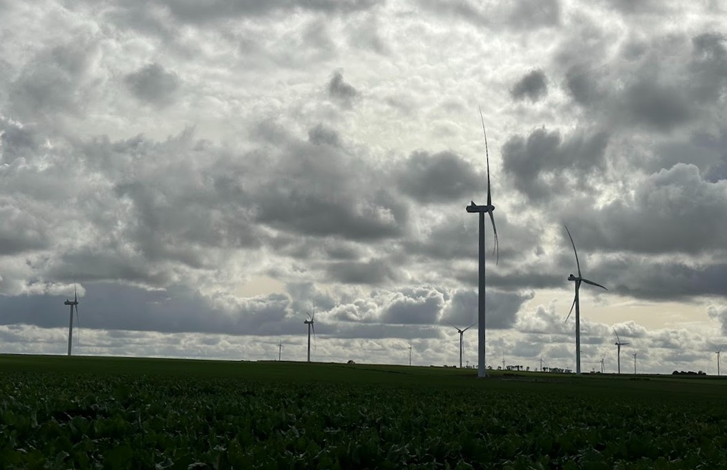 Wind turbines under cloudy sky